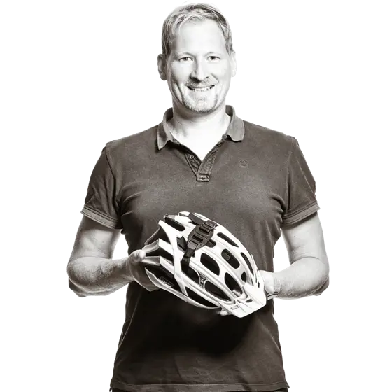 Markus hält einen Fahrradhelm in den Händen.