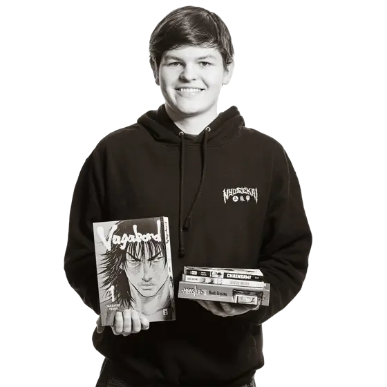 Paul hält Manga-Bücher in den Händen. 
